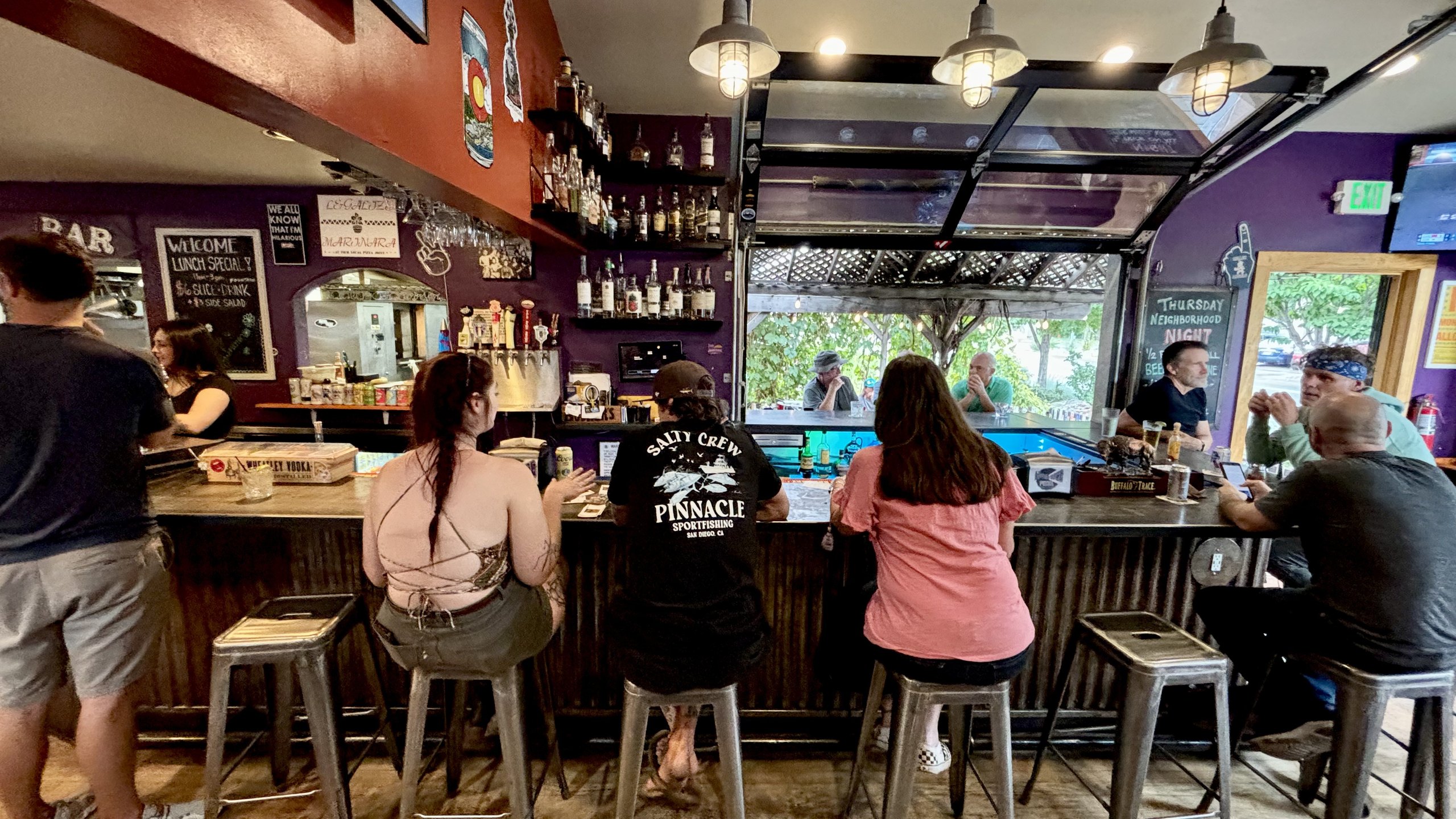 Guests at the bar at HomeSlice Pizza College Drive