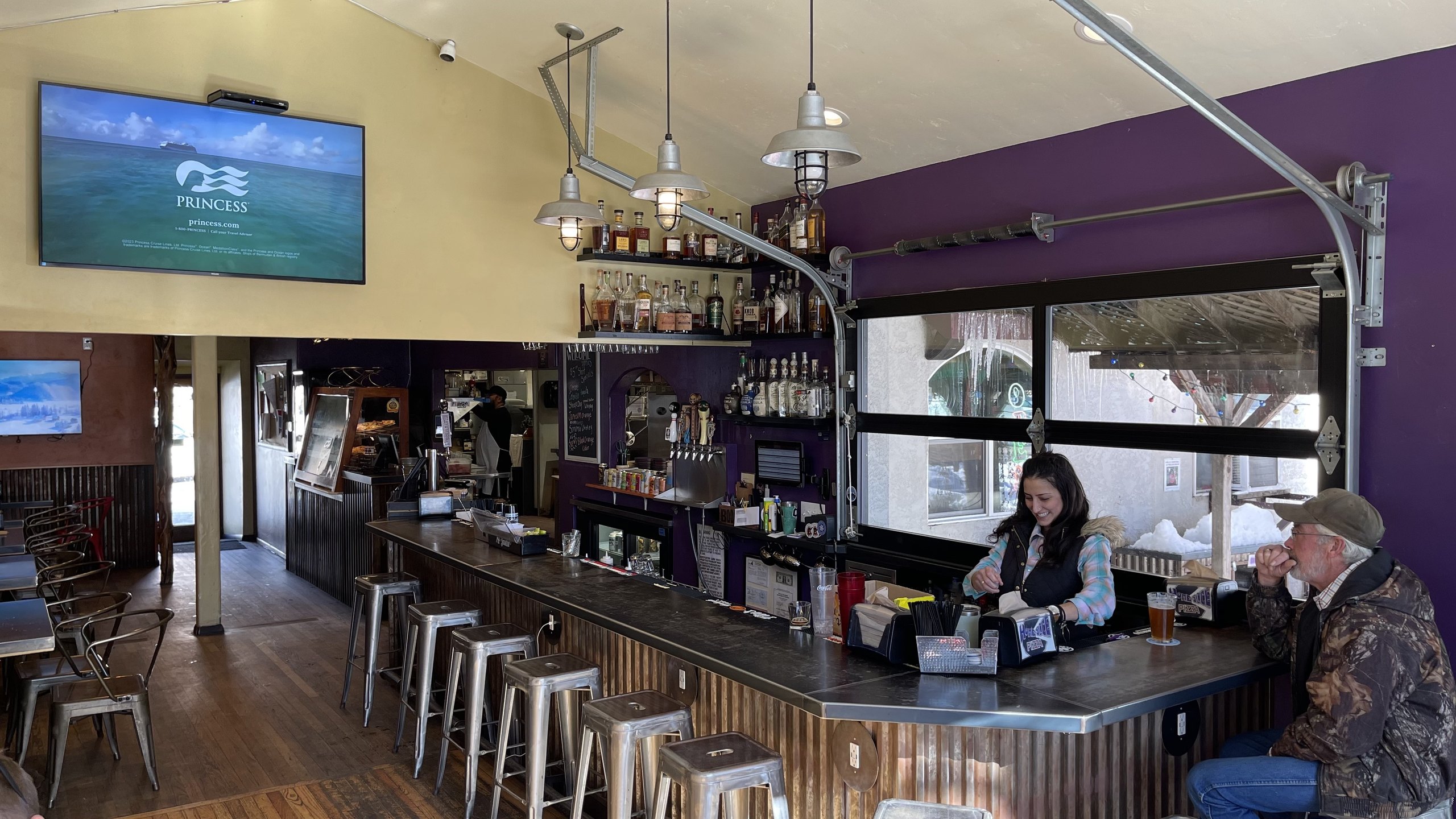 The purple-wall bar at HomeSlice Pizza College Drive