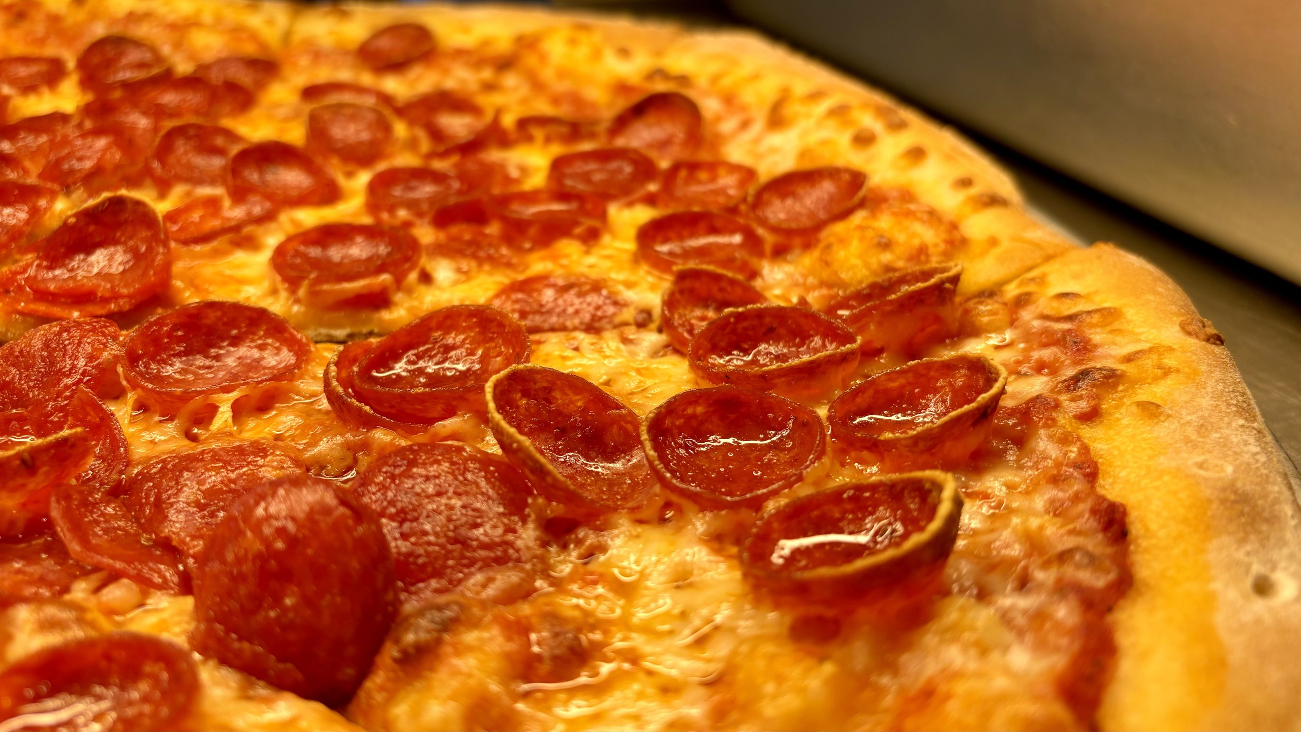 Close-up of a pepperoni pizza fresh from the pan