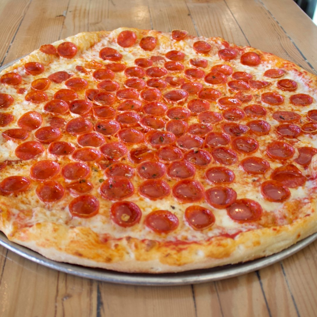 Overhead view of a HomeSlice pizza topped with pepperoni