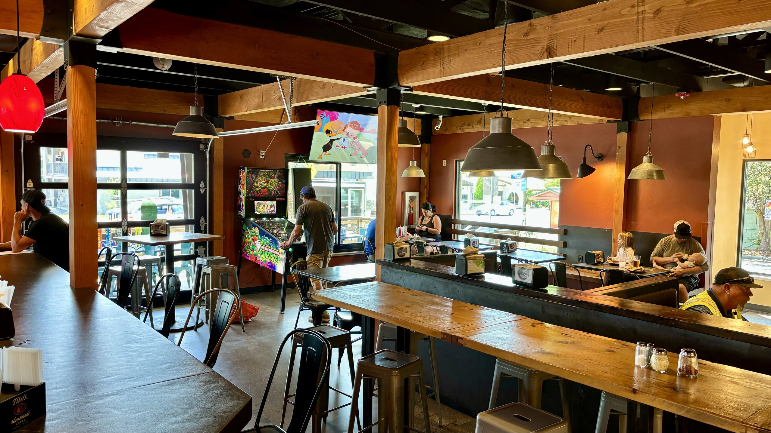 The dining room and TVs at HomeSlice Pizza North Main, ready for game day